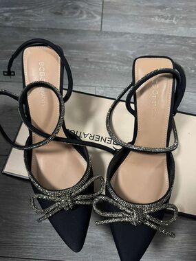 BCBGeneration Black Pointed Toe Ankle-Strap Heels with Rhinestone Bow Accents